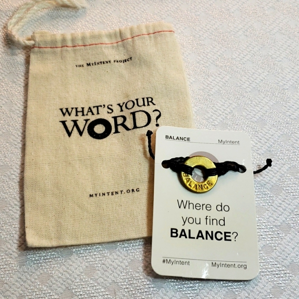 Balance brass on black cord bracelet with bag